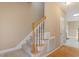 Carpeted staircase with wooden handrail and white spindles leading to the upper level of the home at 933 Richland Ridge Dr, Wake Forest, NC 27587