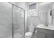 Bathroom features a glass door enclosed shower, vanity, and toilet at 1002 Gilly Ct, Durham, NC 27703