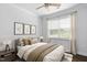 Cozy bedroom with large window, bed, and side table at 1002 Gilly Ct, Durham, NC 27703