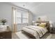 Bright bedroom featuring a large window, soft lighting, and a comfortable, inviting bed at 1002 Gilly Ct, Durham, NC 27703