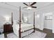 Bedroom features a canopy bed, ensuite bath with marble tile, and dark hardwood floors at 1002 Gilly Ct, Durham, NC 27703