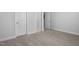 Neutrally decorated bedroom showing plush carpeting and multiple doors at 1002 Gilly Ct, Durham, NC 27703