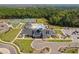 Aerial view of community clubhouse with pool, tennis courts, and parking at 1002 Gilly Ct, Durham, NC 27703