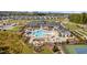 Aerial view of neighborhood pool with lounge chairs, clubhouse, and tennis courts at 1002 Gilly Ct, Durham, NC 27703