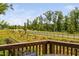 View from the wood deck showcasing neighborhood street and lush greenery at 1002 Gilly Ct, Durham, NC 27703