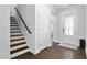 Inviting entryway showcasing hardwood floors, staircase, and front door with decorative glass at 1002 Gilly Ct, Durham, NC 27703