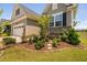 Home exterior featuring well-manicured landscaping including ornamental trees, shrubs, and a charming bench at 1002 Gilly Ct, Durham, NC 27703