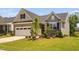 Charming single-Gathering home featuring a two-car garage, neutral siding, and professionally landscaped front yard at 1002 Gilly Ct, Durham, NC 27703