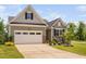 Charming single-Gathering home featuring a two-car garage, neutral siding, and professionally landscaped front yard at 1002 Gilly Ct, Durham, NC 27703