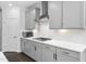 A kitchen featuring white countertops, grey cabinets, stainless steel appliances, and herringbone backsplash at 1002 Gilly Ct, Durham, NC 27703