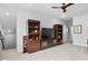 Cozy living room with custom built-in shelving and a ceiling fan for added comfort at 1002 Gilly Ct, Durham, NC 27703