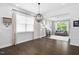 Living room with hardwood floors, a modern chandelier, and plenty of natural light from the large windows at 1002 Gilly Ct, Durham, NC 27703