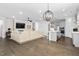 Open concept living room and kitchen with hardwood floors, fireplace, and neutral colored furnishings at 1002 Gilly Ct, Durham, NC 27703