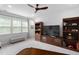 Well-lit living room with large windows, built-in shelving, and plush carpeting at 1002 Gilly Ct, Durham, NC 27703