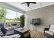 Relaxing screened porch with a TV, comfortable seating, and an inviting outdoor view at 1002 Gilly Ct, Durham, NC 27703