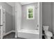 Bathroom with tile floors, and shower/bath combination with modern fixtures at 1003 E Sterlington Pl, Apex, NC 27502