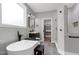 Bright bathroom showcasing a soaking tub, walk-in shower, and closet for storage at 1003 E Sterlington Pl, Apex, NC 27502