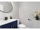 Beautiful bathroom featuring a blue vanity, modern fixtures, and decorative accents at 1003 E Sterlington Pl, Apex, NC 27502