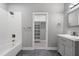 Stylish bathroom with tub/shower combo, decorative wall accents, and gray vanity at 1003 E Sterlington Pl, Apex, NC 27502