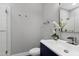 Modern half-bath with floating vanity, statement mirror, and elegant sink at 1003 E Sterlington Pl, Apex, NC 27502
