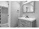 Contemporary bathroom vanity with modern fixtures and view to walk-in closet at 1003 E Sterlington Pl, Apex, NC 27502