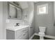 Powder room featuring gray vanity, modern fixtures, and tiled flooring at 1003 E Sterlington Pl, Apex, NC 27502