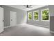 Large bedroom with carpet, ceiling fan, and plentiful natural light from large windows at 1003 E Sterlington Pl, Apex, NC 27502