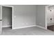 Spacious bedroom with plush carpet, multiple doorways and neutral paint at 1003 E Sterlington Pl, Apex, NC 27502