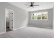 Bedroom with large windows, plush carpet, and doorway to attached bath at 1003 E Sterlington Pl, Apex, NC 27502