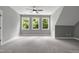 Spacious bedroom with carpet, ceiling fan and large windows at 1003 E Sterlington Pl, Apex, NC 27502