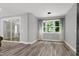 Dining area with sliding glass doors, hardwood floors, a large window and light gray walls at 1003 E Sterlington Pl, Apex, NC 27502