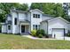 Charming two-story home featuring a two-car garage, complemented by well-manicured landscaping at 1003 E Sterlington Pl, Apex, NC 27502