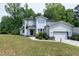 Contemporary-style home with white siding, neat landscaping, and an attached garage at 1003 E Sterlington Pl, Apex, NC 27502