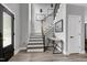 Bright foyer with an open staircase, modern railing, wood flooring, and contemporary design at 1003 E Sterlington Pl, Apex, NC 27502