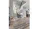 Bright foyer with an open staircase, modern railing, wood flooring, and contemporary design at 1003 E Sterlington Pl, Apex, NC 27502