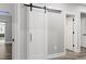 Hallway with sliding barn door leading to rooms at 1003 E Sterlington Pl, Apex, NC 27502