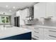 Close up of the kitchen with white cabinets, stainless steel appliances, and modern design at 1003 E Sterlington Pl, Apex, NC 27502