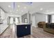 Open kitchen and living area, with an island, stainless steel appliances, and hardwood floors at 1003 E Sterlington Pl, Apex, NC 27502