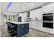 Modern kitchen featuring stainless steel appliances, white cabinets, island, and modern design at 1003 E Sterlington Pl, Apex, NC 27502