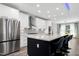 Kitchen with island, stainless steel appliances, range hood, and hardwood floors at 1003 E Sterlington Pl, Apex, NC 27502