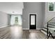 Living room with wood flooring and a large picture window that provides lots of natural light at 1003 E Sterlington Pl, Apex, NC 27502