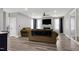 Cozy living room features a fireplace, TV, hardwood floors, and light gray walls at 1003 E Sterlington Pl, Apex, NC 27502