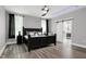 This main bedroom features a large bed, hardwood floors, and recessed ceiling lights at 1003 E Sterlington Pl, Apex, NC 27502