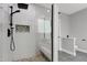 Glass enclosed shower features pebble floor, built in bench, and dual shower heads at 1003 E Sterlington Pl, Apex, NC 27502