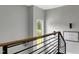 Modern staircase with wood and metal railing, natural light and artwork on the wall at 1003 E Sterlington Pl, Apex, NC 27502