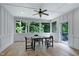 The sunroom is bright and airy with a table and chairs, and access to the back deck at 1003 E Sterlington Pl, Apex, NC 27502