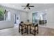 Bright sunroom with view to patio, table and chairs, and access to living room at 1003 E Sterlington Pl, Apex, NC 27502