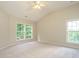 Spacious primary bedroom with vaulted ceiling and natural light at 1010 Starita Ct, Apex, NC 27502
