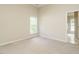 Clean and bright bedroom with neutral carpet and ample closet space at 1010 Starita Ct, Apex, NC 27502