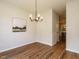 Dining area showcasing hardwood floors, modern lighting, and a view into the kitchen at 1010 Starita Ct, Apex, NC 27502